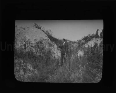 E. J. Iddings among vegetation.