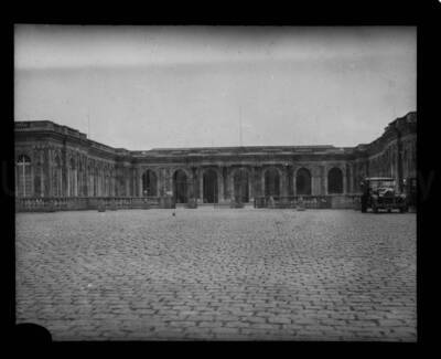 A stone building with a cobblestone pavilion in the foreground.