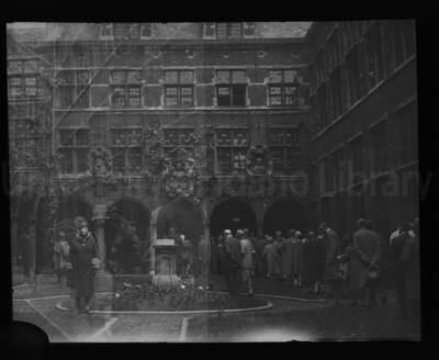 Group of people touring the patio of a building.
