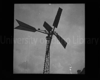 A wooden windmill in an unknown location.