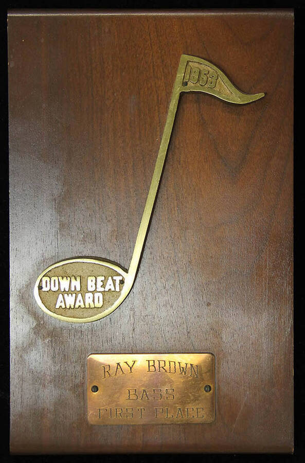 Down Beat Award presented to Ray Brown Bass First Place, 1953.  10 x 6 3/8 inch wood finish plaque with musical theme and engraved plate.