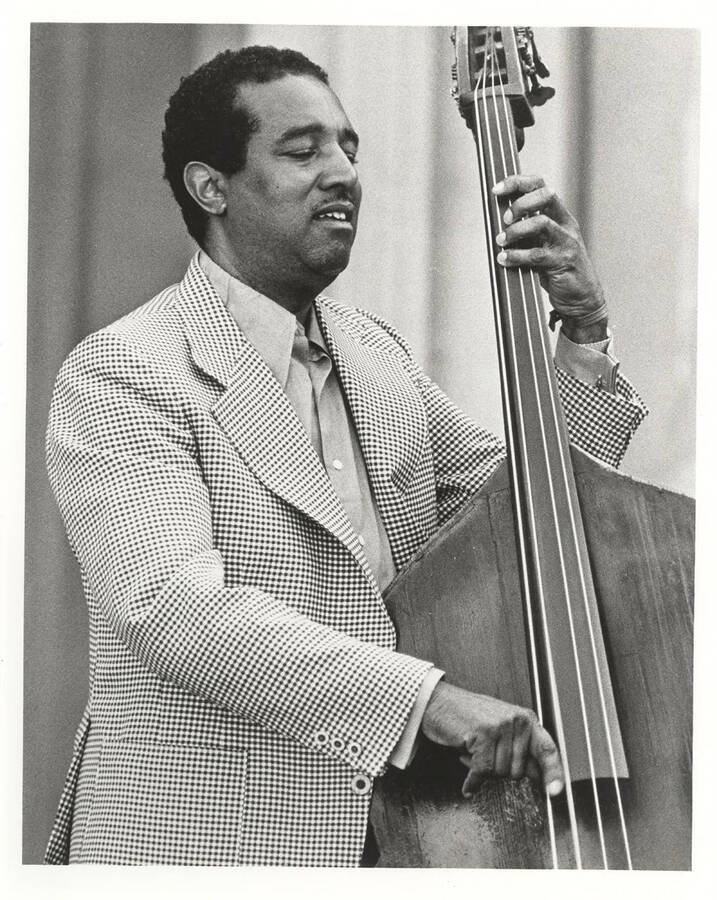 Ray Brown playing the bass, facing right.  10 x 8 inch black and white photograph.