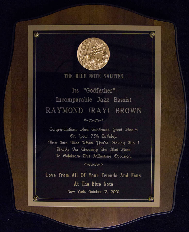 The Blue Note salutes its Godfather jazz bassist Raymond (Ray) Brown on his 75th birthday, New York, October 13, 2001.  14 x 11 1/2 inch wood finish plaque with engraved plate.