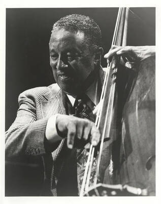 Ray Brown playing the bass, facing left