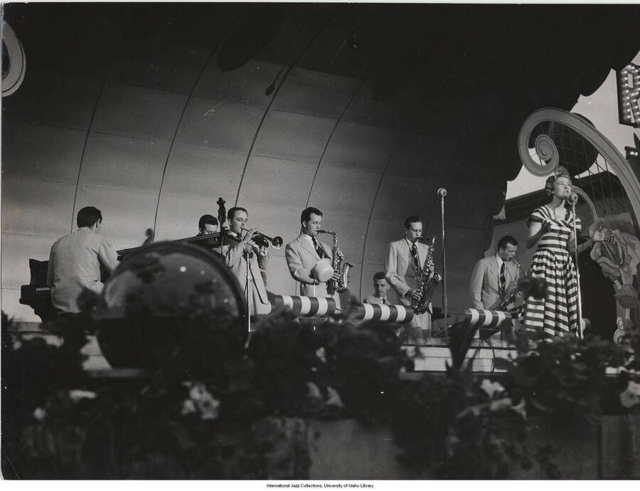 7 x 9 1/2 inch photograph; unidentified woman vocalist performing with orchestra