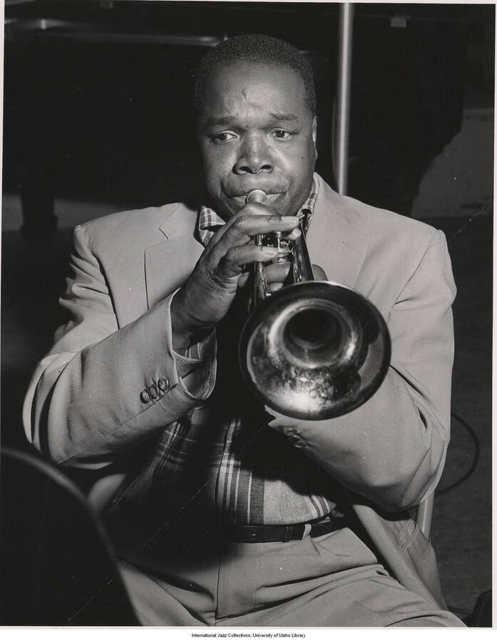 9 x 7 inch photograph; Thad Jones playing the trumpet. Label on the back of the photograph reads: Recording Leonard Feather's Hi Fi Suite for MGM Records: Thad Jones; Album features all-star orchestra directed by Feather and pianist-arranger Dick Hyman