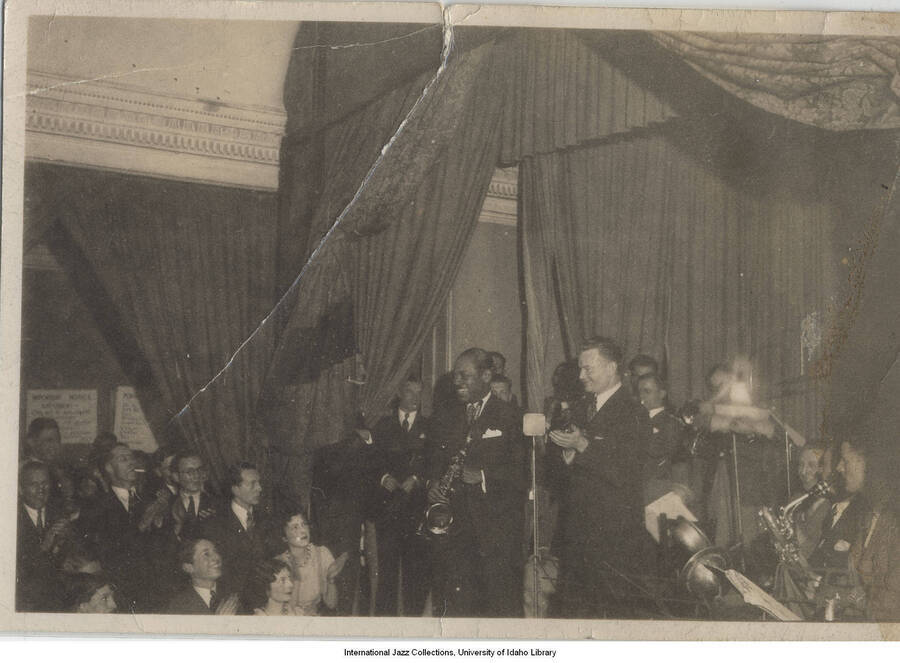 2 3/8 x 3 1/2 inch photograph; Saxophonist Coleman Hawkins and musicians with audience