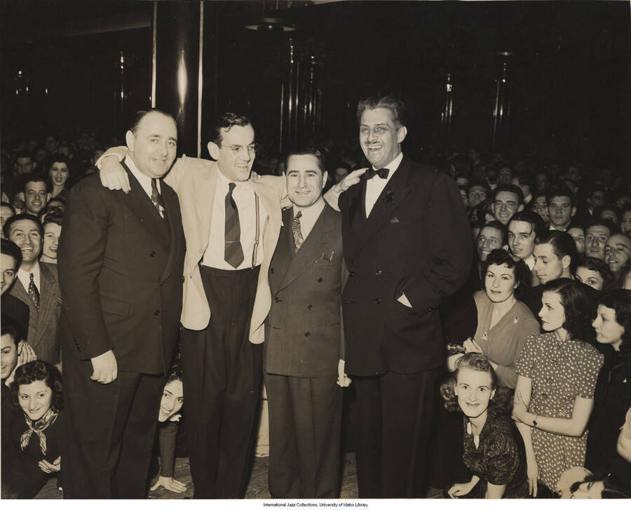 8 x 10 inch photograph; Mal Hallett with three unidentified men surrounded by audience. Stamped on the back of the photograph: George B. Evans, NY; handwritten: Roseland, Lou Brecker?
