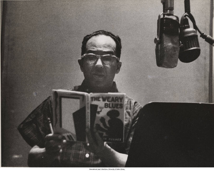 8 x 10 inch photograph; Langston Hughes reading from The Weary Blues in a recording studio