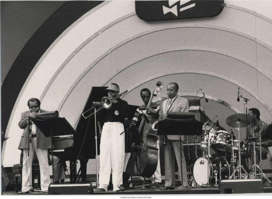 5 x 7 inch photograph; unidentified musicians performing. Observable above the stage is the logo of Playboy Magazine