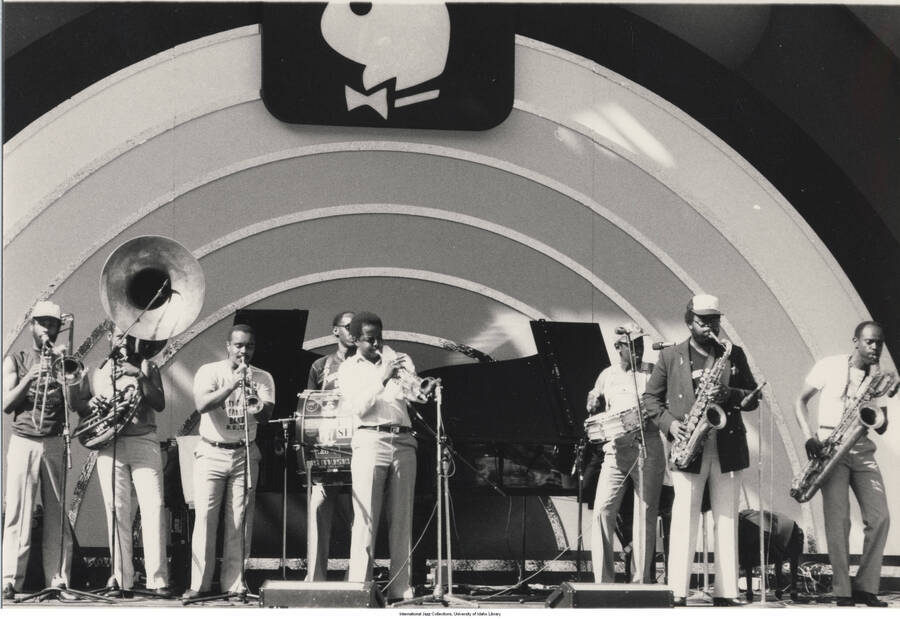 5 x 7 inch photograph; unidentified musicians performing. Observable above the stage is the logo of Playboy Magazine