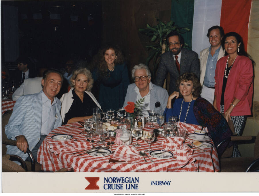 5 x 6 3/4 inch photograph; Group of people at a dinner table. Handwritten on the back of the photograph: John and Diane McDevough?, Chicago; 1988-10 Cruise. Inscription at the bottom of the photograph reads: Norwegian Cruise Line