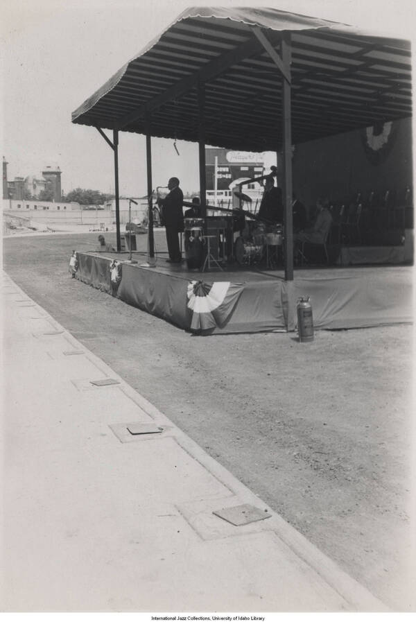 5 x 3 1/2 inch photograph; unidentified saxophonist performing in an improvised stage in a stadium
