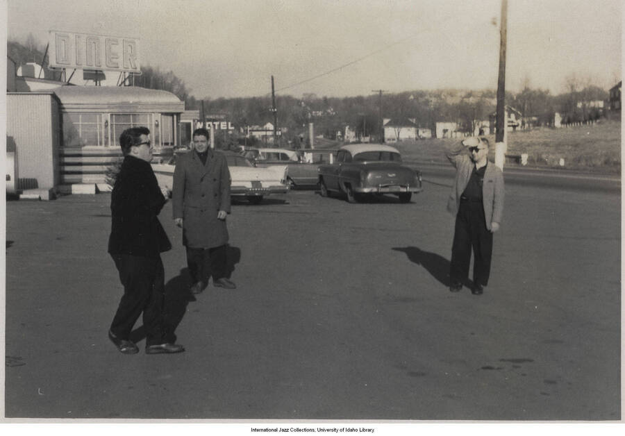 3 1/2 x 5 inch photograph; three unidentified men in a parking lot