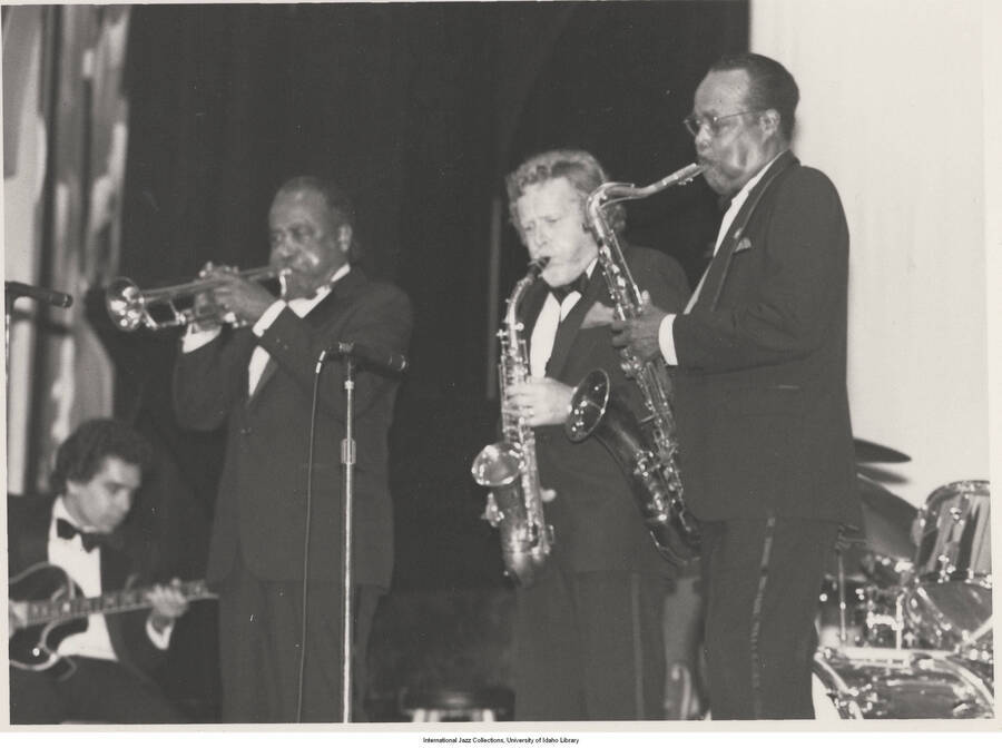 5 x 7 inch photograph; Howard Alden on guitar, Harry Edison on trumpet, Bob Wilber on soprano sax, Buddy Tate on tenor sax, performing