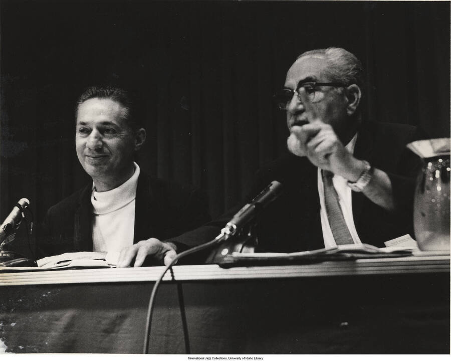 8 x 10 inch photograph; Leonard Feather with an unidentified man at a conference