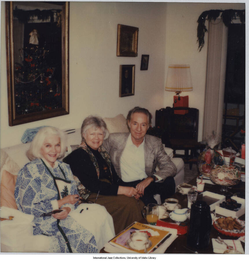 4 1/4 x 3 1/2 inch Polaroid photograph; Leonard Feather and unidentified friends celebrating a holiday in a home