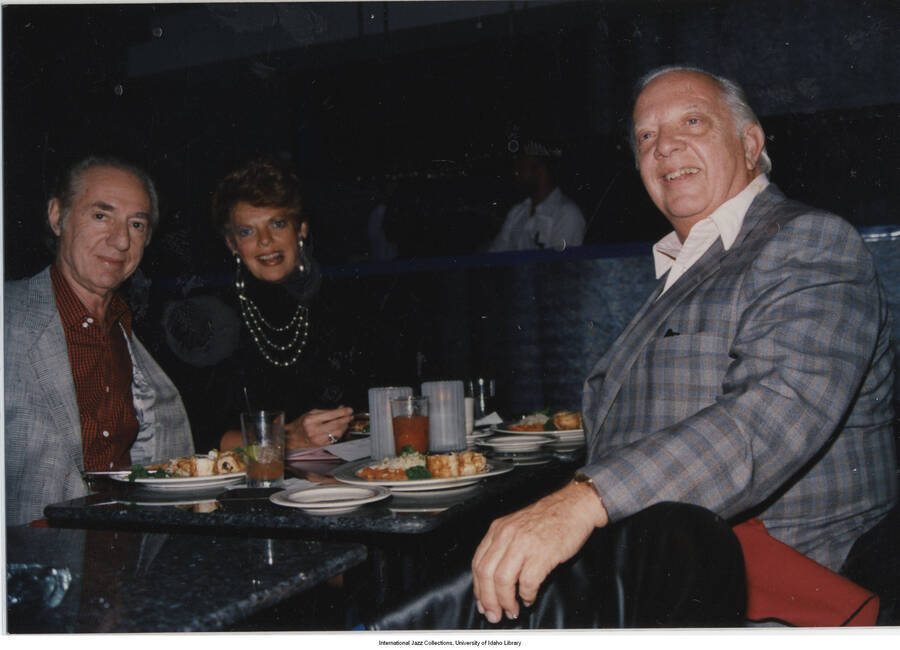 3 1/2 x 5 inch photograph; Leonard Feather with unidentified man and woman, in a restaurant