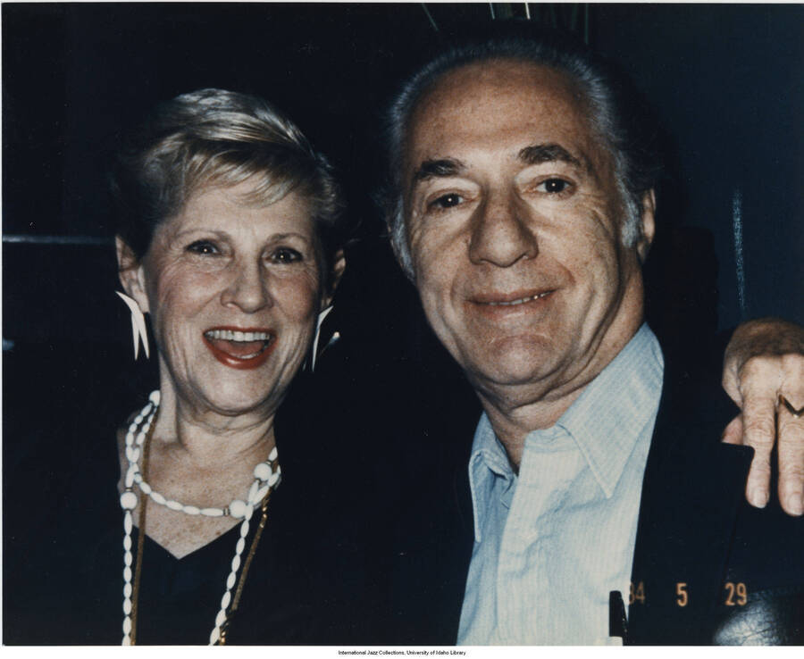 9 x 10 inch photograph; Leonard Feather with an unidentified woman