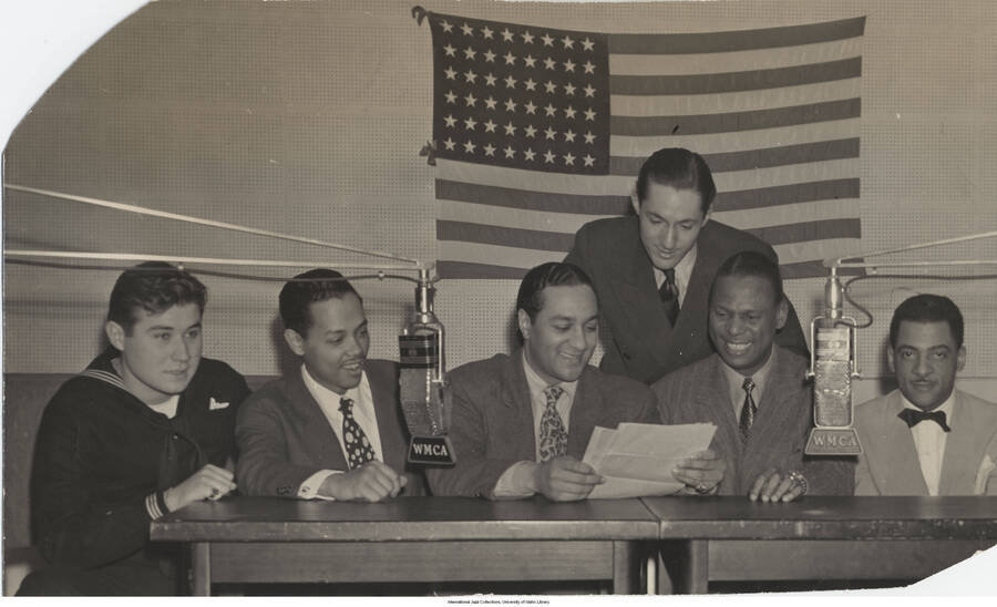 4 1/2 x 7 3/4 inch photograph; Platterbrains WMCA radio show. Left to right: Bob Thiele, Billy Eckstine, Ralph Cooper, Leonard Feather, Earl Hines, and Teddy Wilson. This photograph is published in Leonard Feather's book The Jazz Years: Earwitness to an era