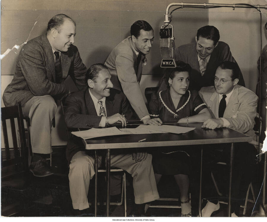 8 x 10 inch photograph; WMCA radio show. Left to right: Milton Gabler, Bob Bach, Leonard Feather, Andre Baruch, Bea Wain, and Tommy Dorsey