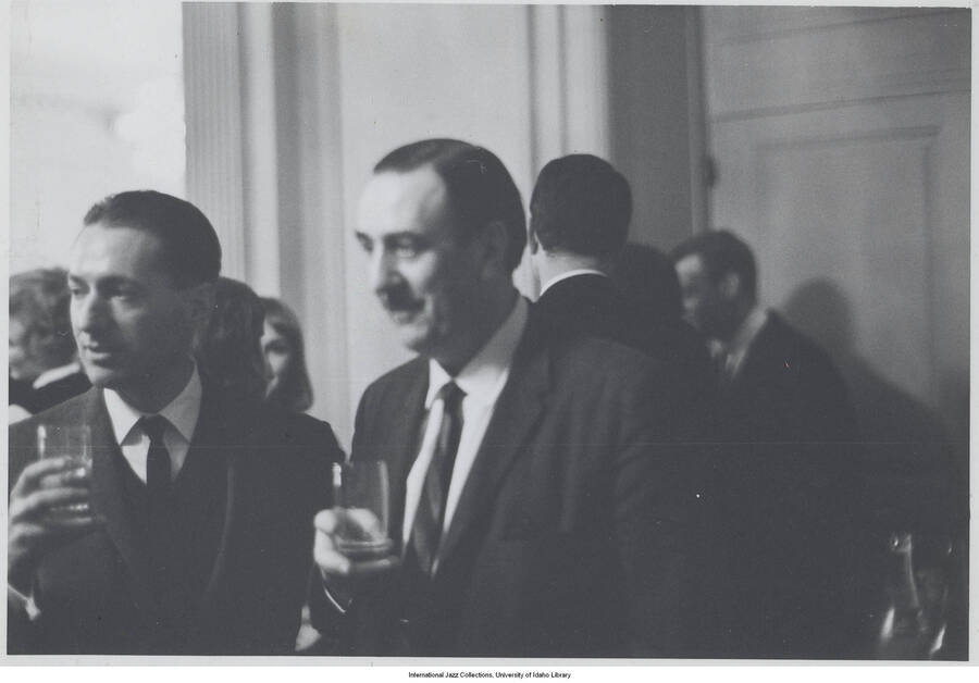 3 1/2 x 5 inch photograph; Leonard Feather with unidentified man at a cocktail party
