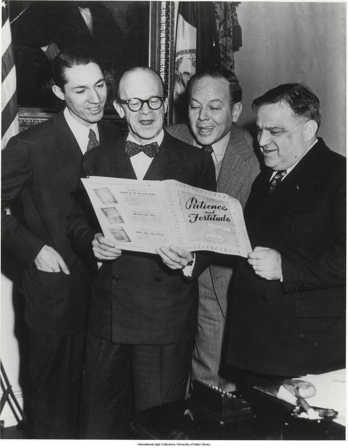 10 x 8 inch photograph. Handwritten on the back of the photograph: Deems Taylor, Raymond Paige (then musical director of Radio City Music Hall), and Mayor Fiorello LaGuardia singing "Patience and Fortitude," a song by Billy Moore Jr., named for Mayor LaGuardia's famous radio sign-off slogan