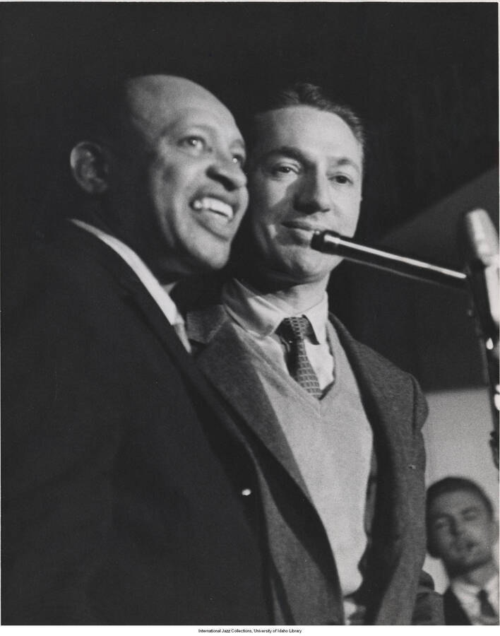 10 x 8 inch photograph. Lionel Hampton and Leonard Feather. Handwritten on the back of the photograph: Lionel Hampton and Leonard Feather broadcasting from the summit on Knob. L.A., 1962