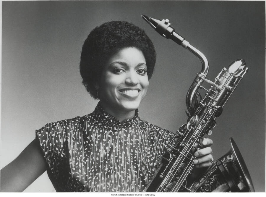 10 x 8 inch signed photograph; unidentified woman holding a saxophone. The photograph is dedicated to Leonard Feather