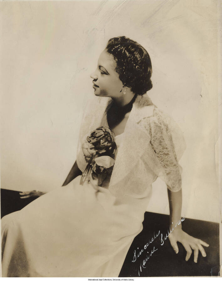 10 x 8 inch signed photograph; Maxine Sullivan. Handwritten on the back of the photograph: Seventeen-year-old swing vocalist. The photograph has a dedication