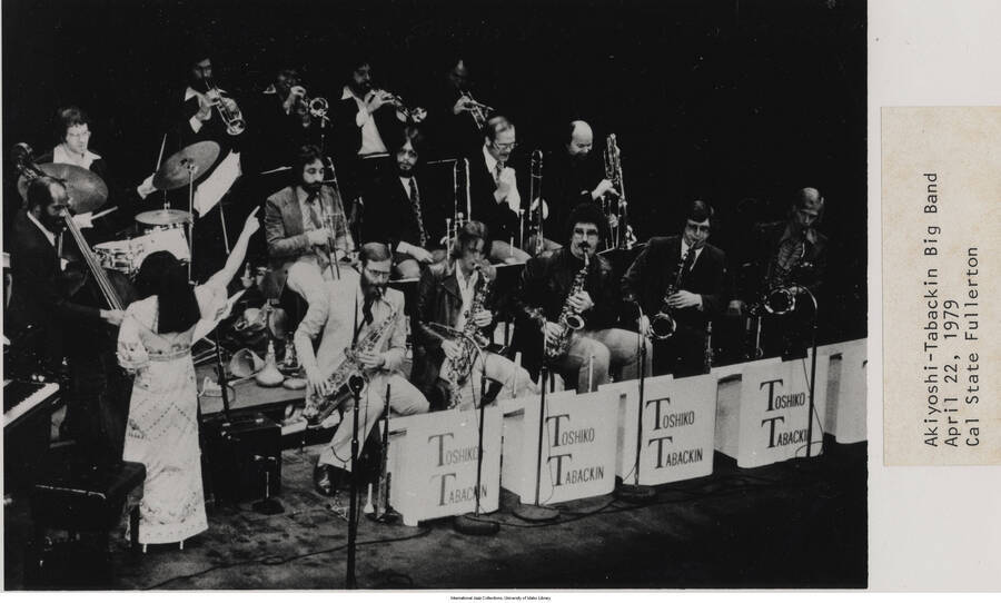 5 x 8 1/8 inch photograph; Akiyoshi-Tabackin Big Band. Label on the front of the photograph reads: Akiyoshi-Tabackin Big Band. 1979-04-22. Cal State Fullerton