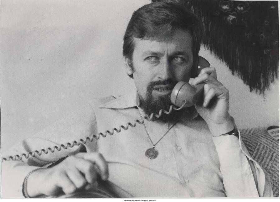5 x 7 inch photograph; Adam Makowicz talking on the telephone