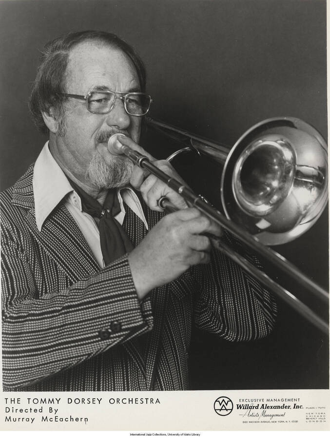 10 x 8 inch photograph; Murray MacEachern playing the trombone. Inscription at the bottom of the photograph reads: The Tommy Dorsey Orchestra, directed by Murray McEachern
