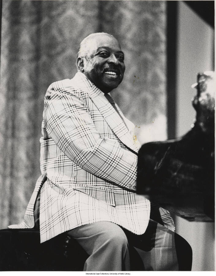 10 x 8 inch photograph; Count Basie playing the piano. Handwritten on the back of the photograph: Dan Baliotti