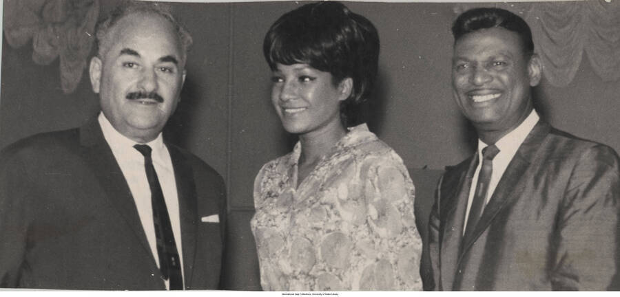 4 x 8 3/4 inch photograph; Clea Bradford, Little Richard, and an unidentified man. Inscriptions on the back is illegible and includes words in French; also the name: Apollon Kipianni, director of philharmonic