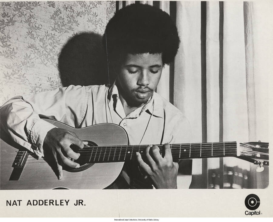 8 x 10 inch photograph; Nat Adderley Jr. playing the guitar