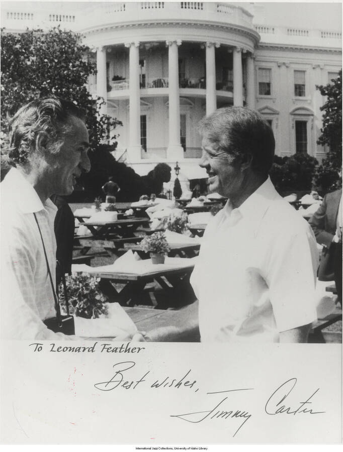 10 x 8 inch signed photograph; Leonard Feather shaking hands with President Jimmy Carter. Handwritten on the back of the photograph: White House jazz party, 1978. This is a copy of the photograph dedicated to Leonard Feather. This photograph is published in Leonard Feather's book The Jazz Years: Earwitness to an era