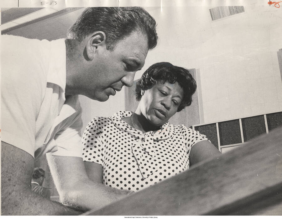 11 x 14 inch photograph; Ella Fitzgerald and Nelson Riddle. Handwritten on the back of the photograph: Phil Stern. Gershwin Songbook; Red & Black