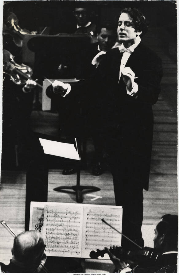 13 1/2 x 8 1/2 inch photograph; unidentified orchestra conductor performing. Crossed out on the back of the photograph is the following handwritten information: For easel di[splay] only. Not publicati[on]. The back of the photograph is also stamped with the words: Barna Ostert[ag?], New York; and handwritten: David [Amr...?]