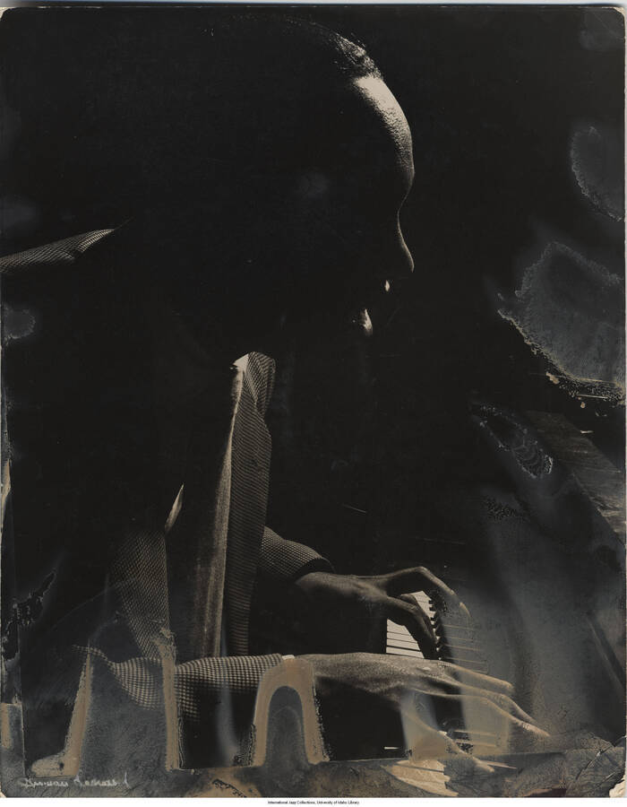 13 3/4 x 11 inch photograph; Tadd Dameron playing the piano. Photograph affixed to cardstock