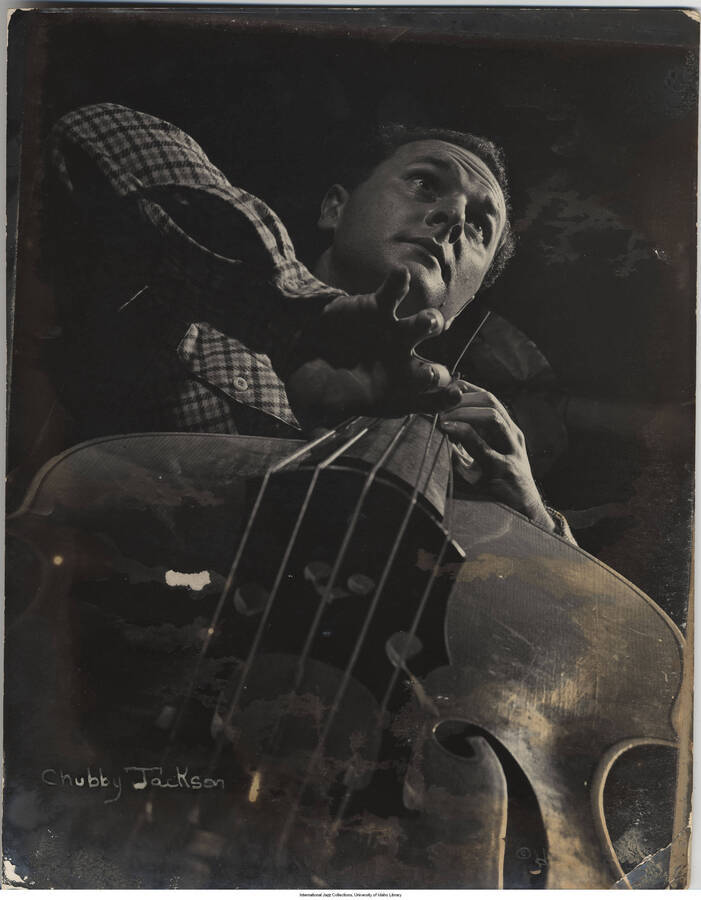 13 3/4 x 10 3/4 inch photograph; Chubby Jackson playing the bass. Photograph affixed to cardstock