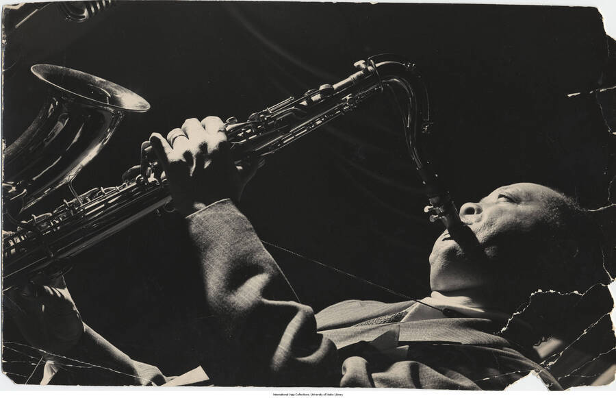 14 x 8 3/4 inch photograph; Lester Young playing the saxophone