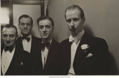 3 x 4 3/4 inch photograph; four men. Handwritten on the back of the photograph: Bill Handy, Glen Miller, unknown, Ray Noble