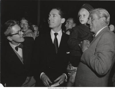 7 x 9 1/2 inch photograph; Leonard Feather with unidentified persons