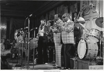 3 1/2 x 5 inch photograph; performing are Ray Brown on bass, Benny Carter on trumpet, Buddy Tate on tenor sax, and unidentified others