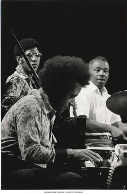 7 3/4 x 5 1/4 inch photograph; pianist Hampton Hawes and unidentified musicians performing