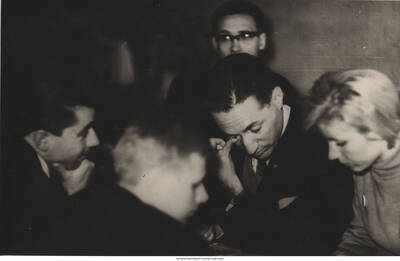 4 1/2 x 6 3/4 inch photograph; Leonard Feather with unidentified men and woman