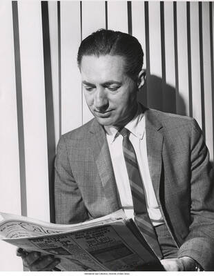 10 x 8 inch photograph. Leonard Feather reading the Calendar from the Los Angeles Times