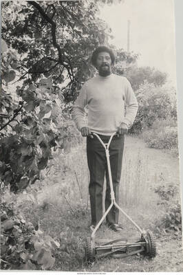 7 1/2 x 5 inch signed photograph; [Larry Ridley]. Handwritten on the back of the photograph: From my garden; playing in the yard
