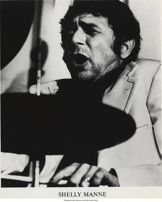 10 x 8 inch photograph; Shelly Manne playing the drums